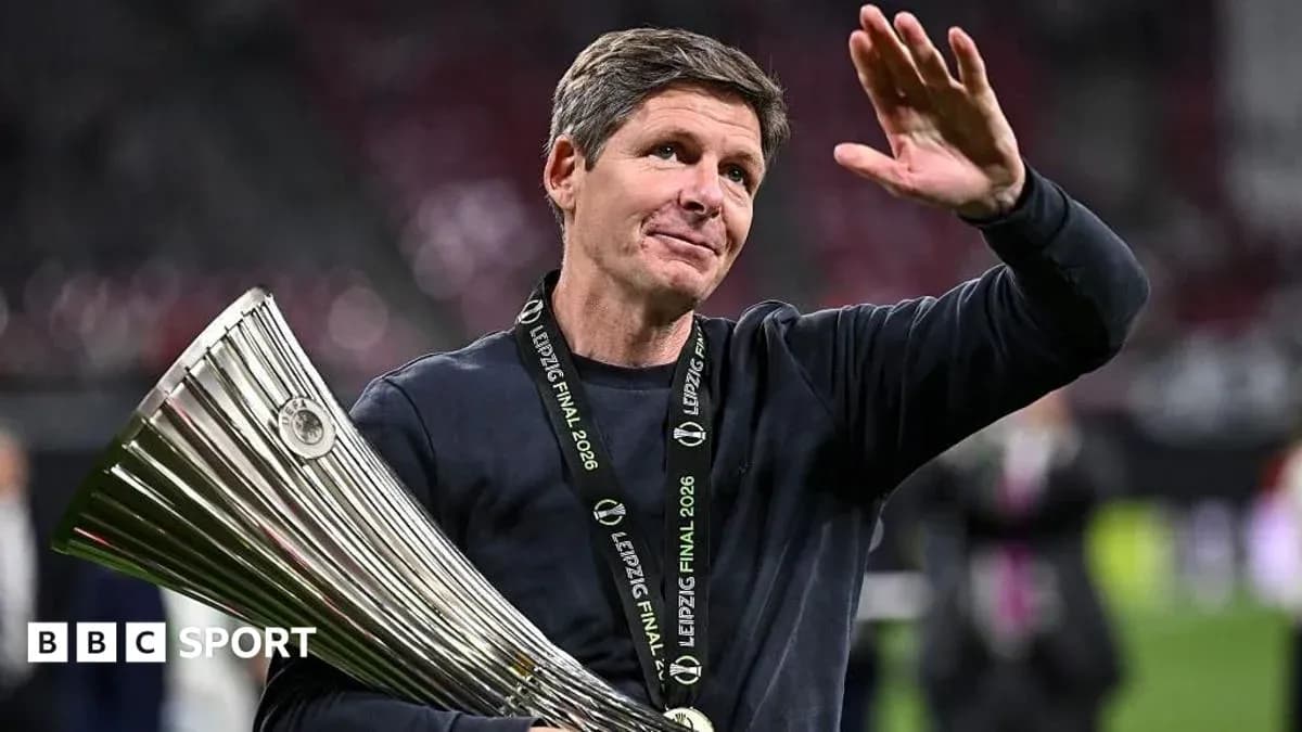 Coach holding trophy and waving after victory