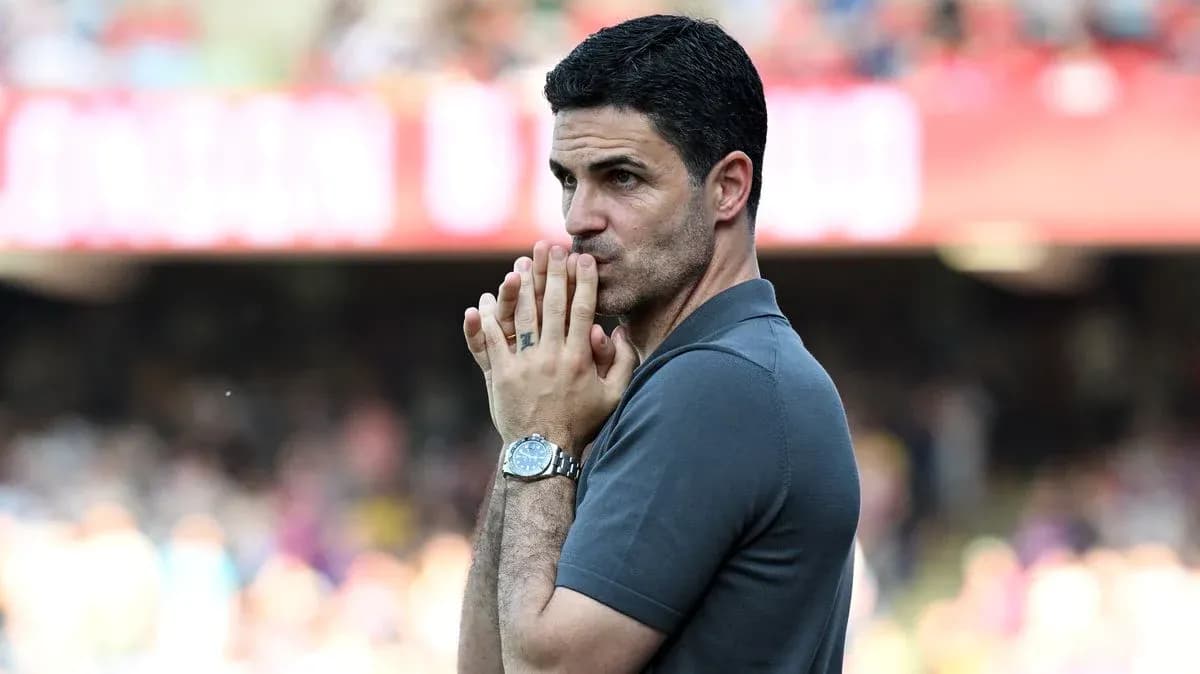 Manager observing match with hands clasped together