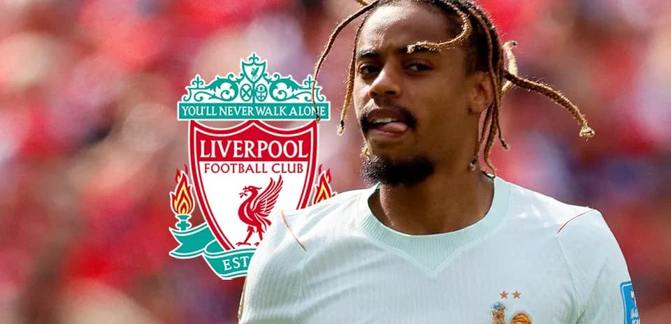 Player in France kit with Liverpool logo background