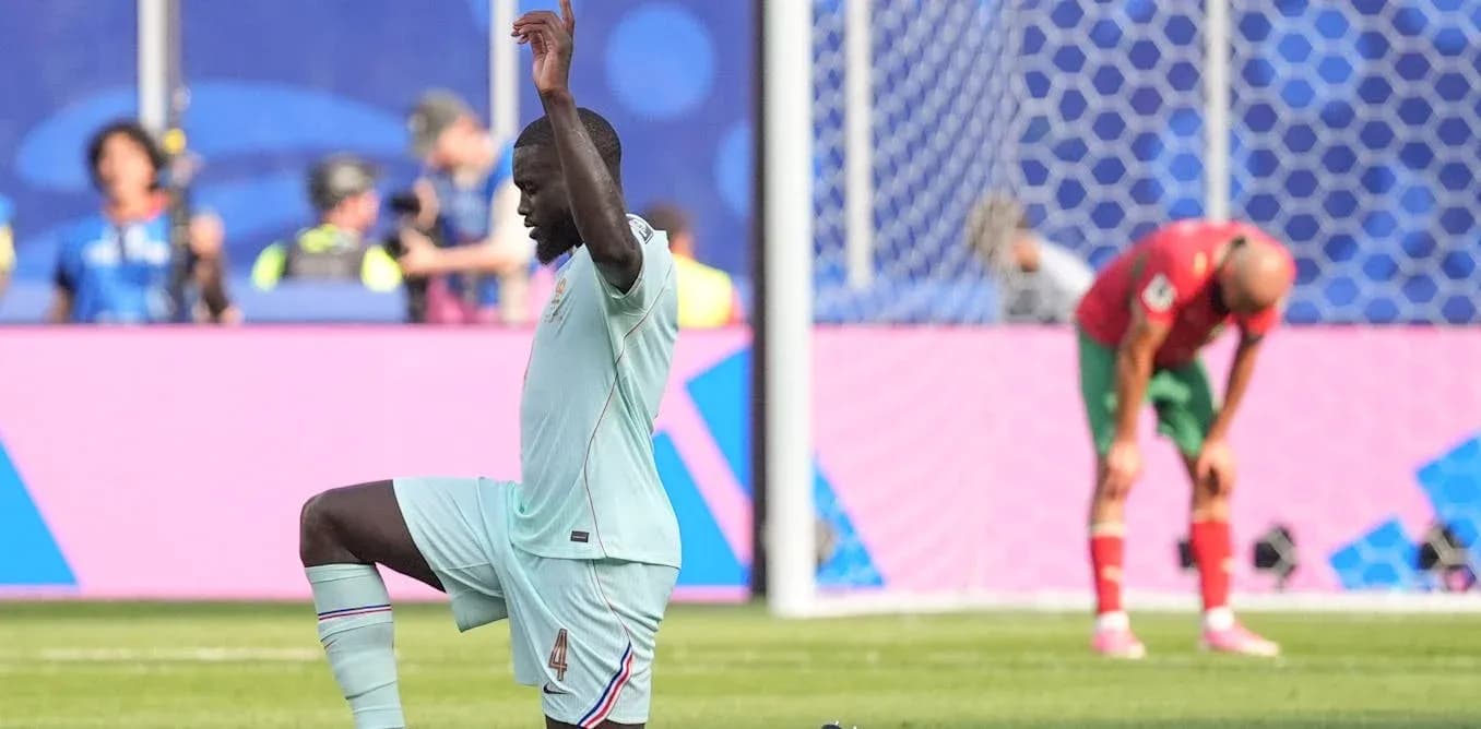 Player kneeling on pitch during match action