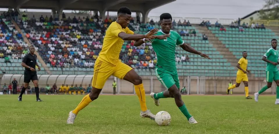 Players competing for the ball in CAF match