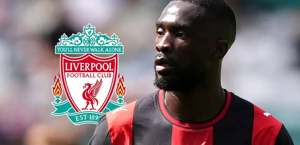 Player in jersey with Liverpool logo in background