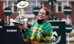 Jockey celebrating with trophy at racing event