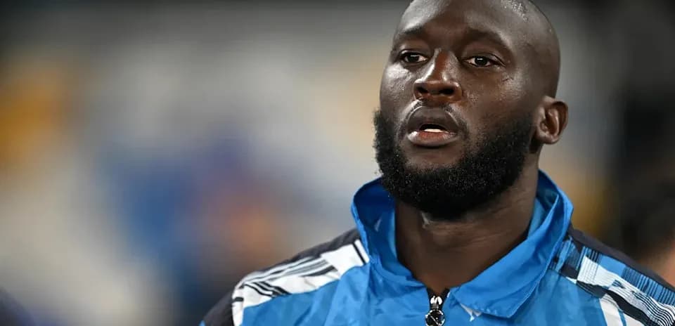 Player wearing blue training jacket on the field