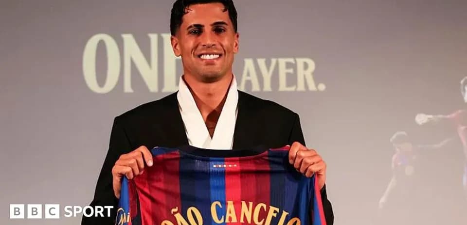 Player holding FC Barcelona jersey at presentation