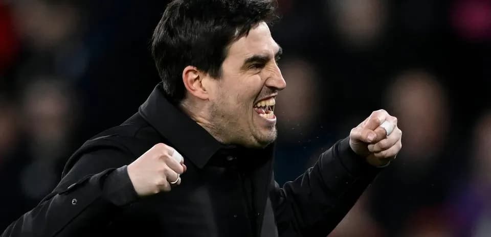 Coach celebrating passionately on the sidelines