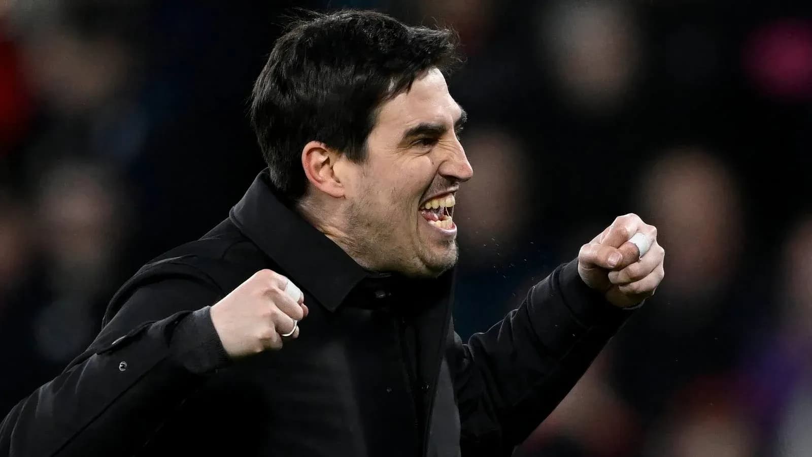 Coach celebrating passionately on the sidelines