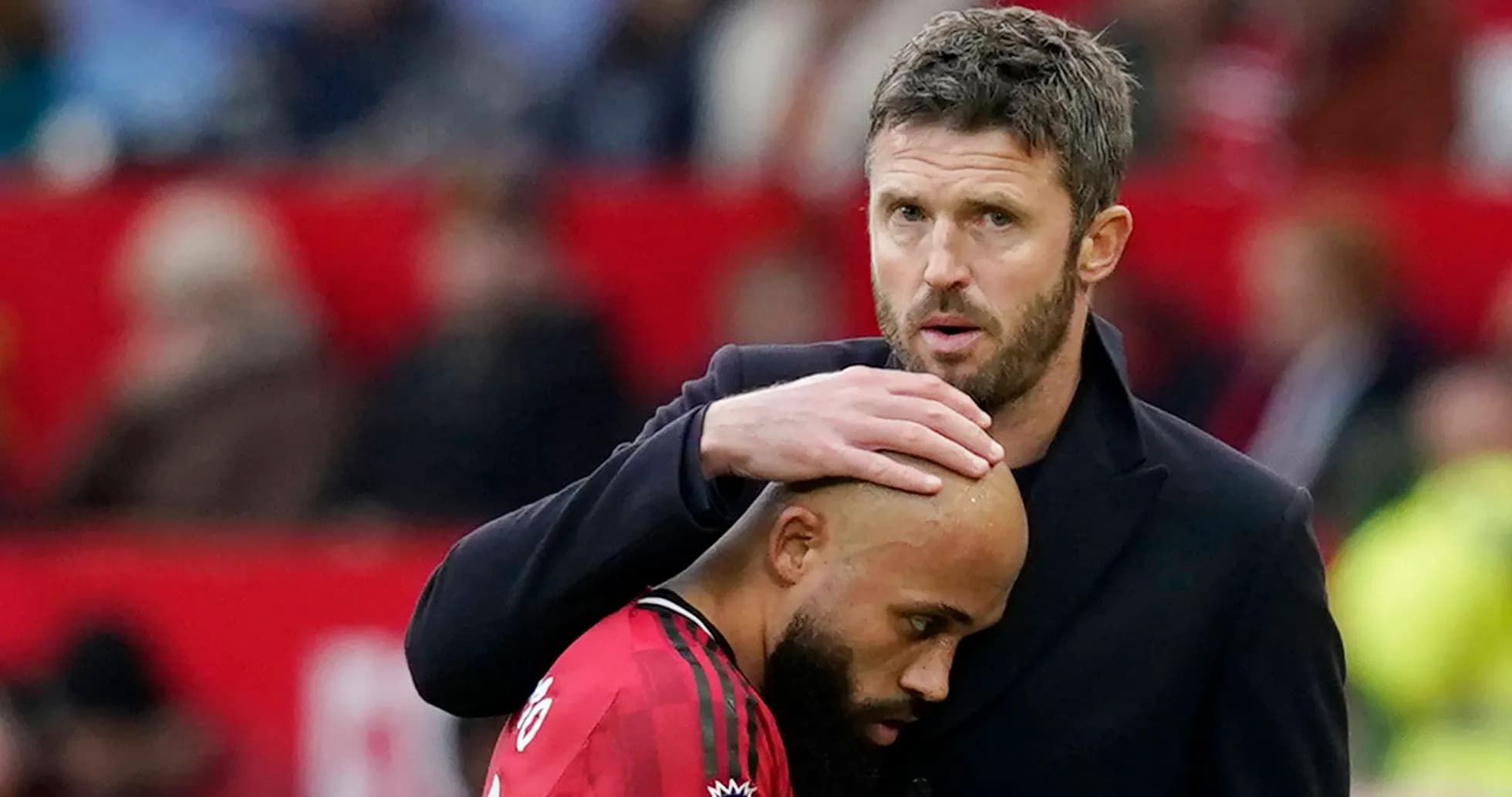 Coach comforting player during match at stadium