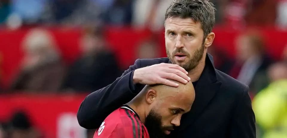 Coach comforting player during match at stadium