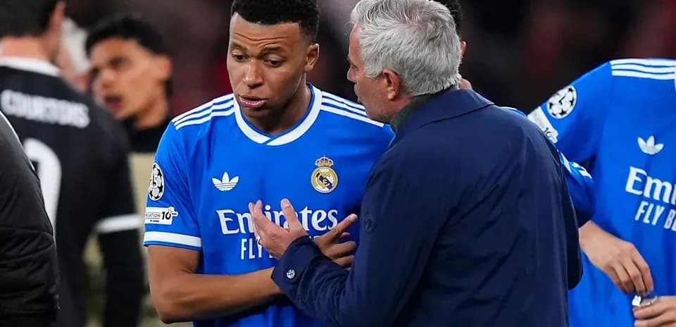 Manager discussing tactics with player on field
