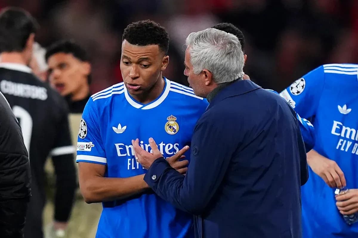 Manager discussing tactics with player on field
