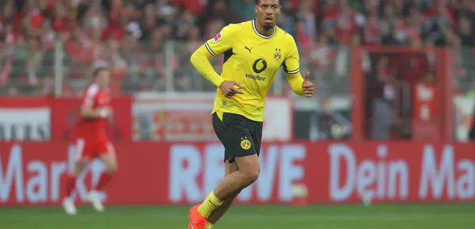 Player in yellow kit celebrating during a match