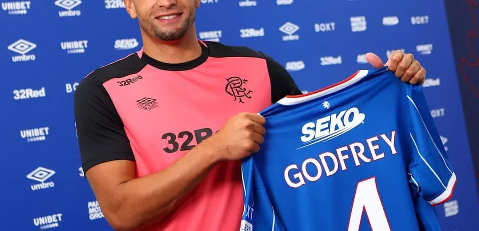 Player holding Rangers FC jersey with 'GODFREY' number 4