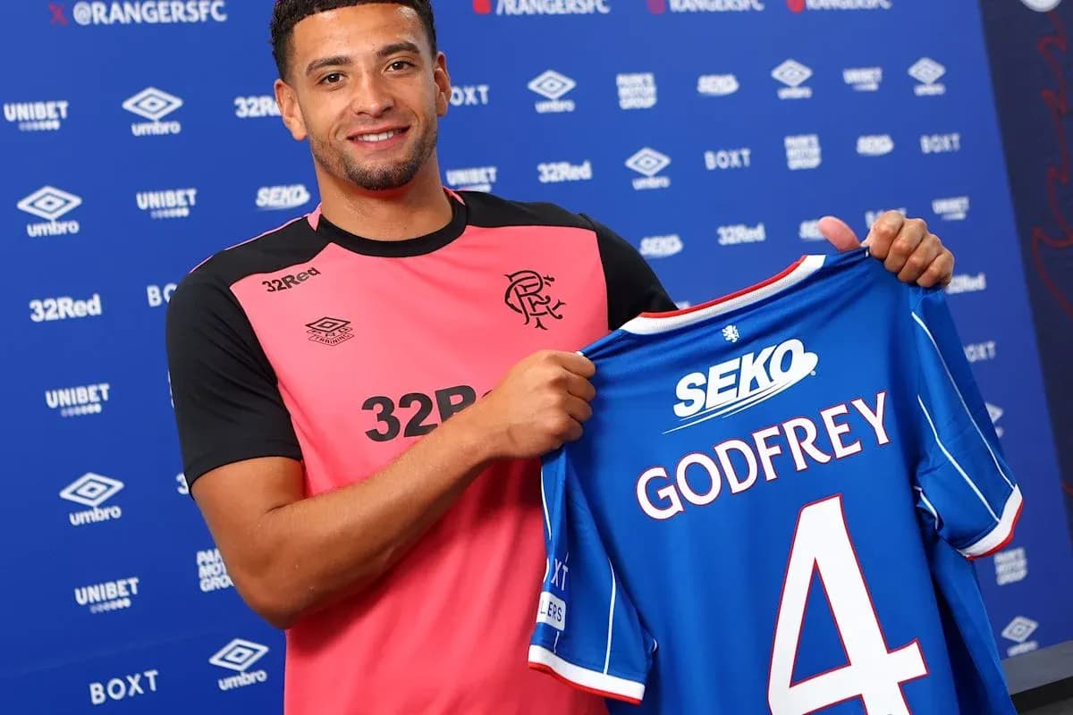 Player holding Rangers FC jersey with 'GODFREY' number 4
