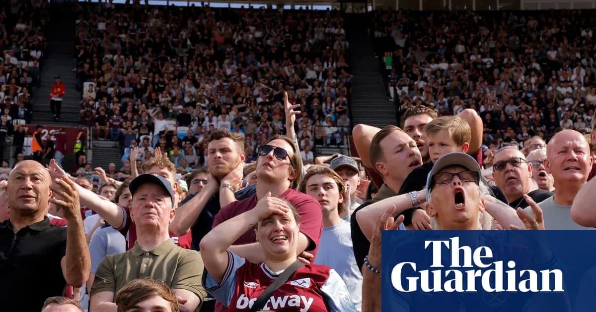 Crowd reacting during a football match in stadium