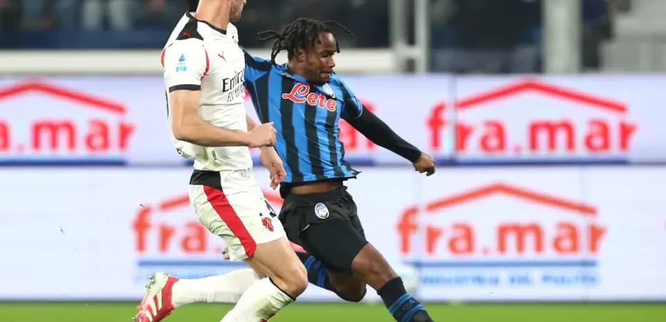 AC Milan player challenged by Atalanta opponent