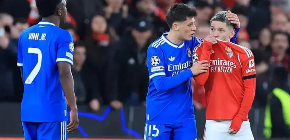 Real Madrid players consoling Benfica player on pitch