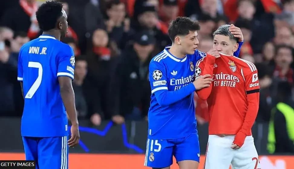 Real Madrid players consoling Benfica player on pitch Real Madrid players consoling Benfica player on pitch