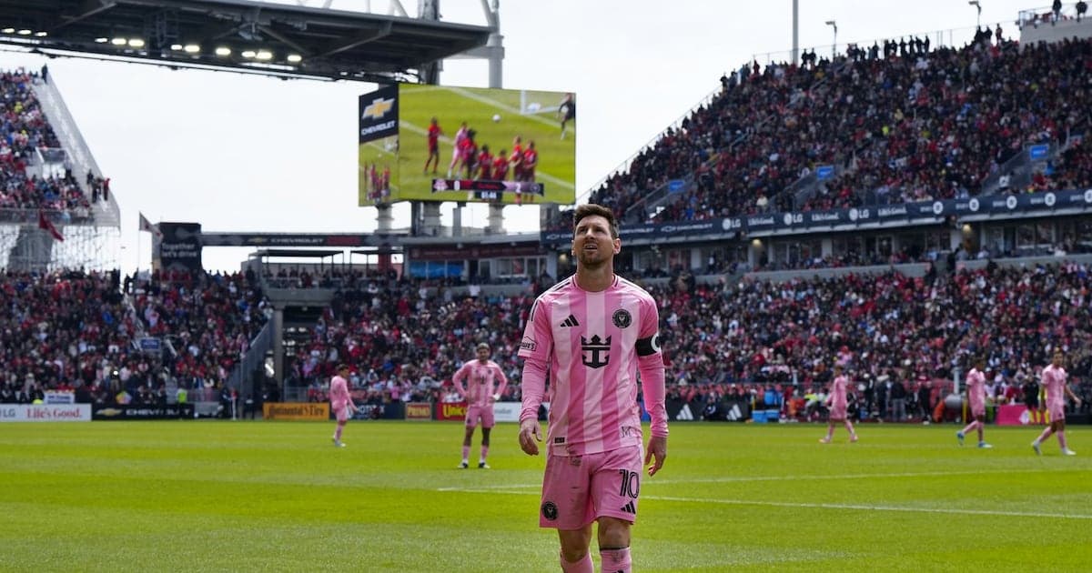 Lionel Messi walking on field during match