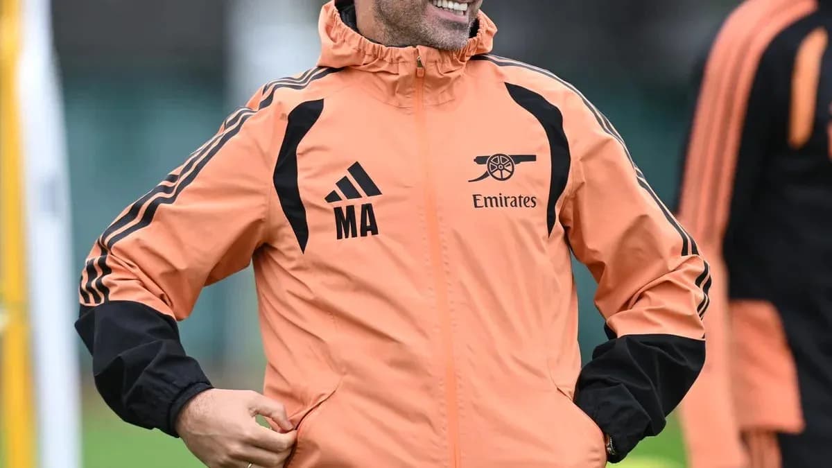 Coach smiling during training session in Arsenal jacket