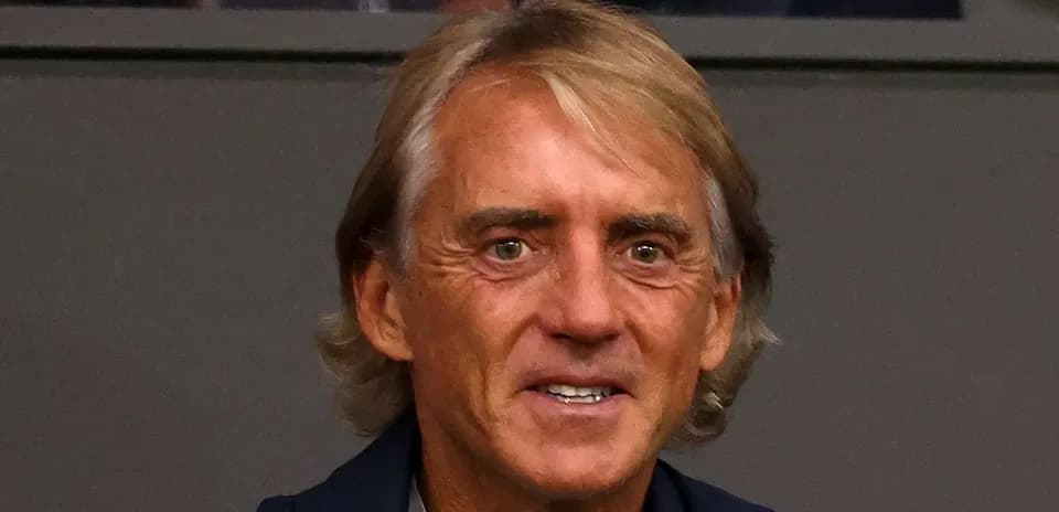 Man smiling in a formal setting