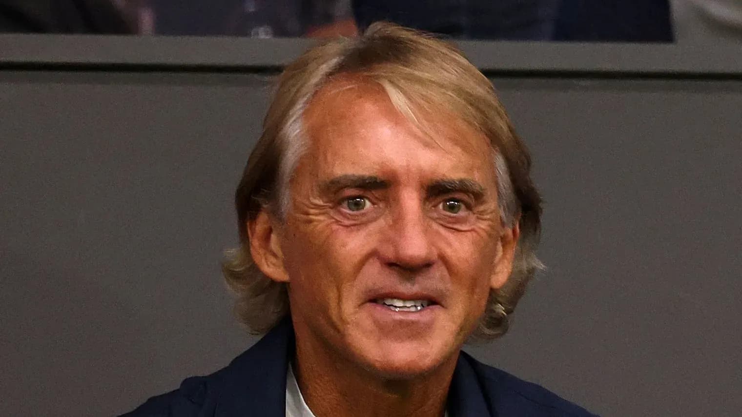 Man smiling in a formal setting