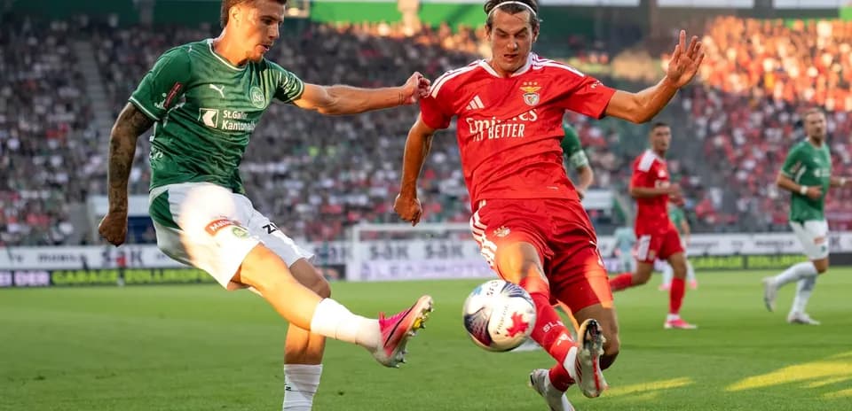 Benfica player challenging FC St. Gallen opponent