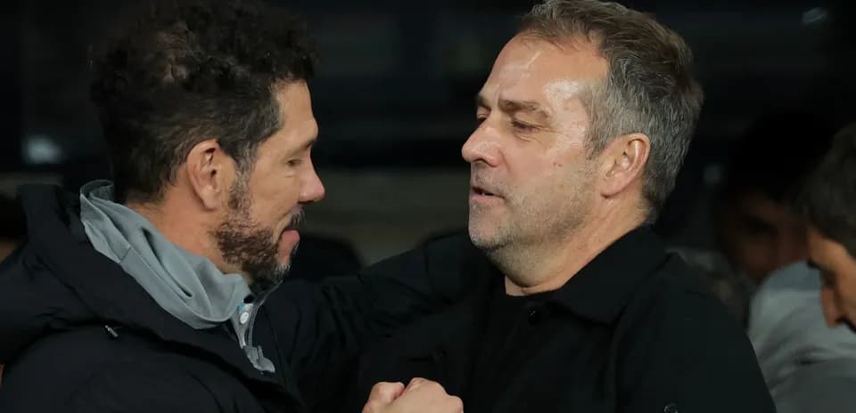 Two coaches embracing during a match event