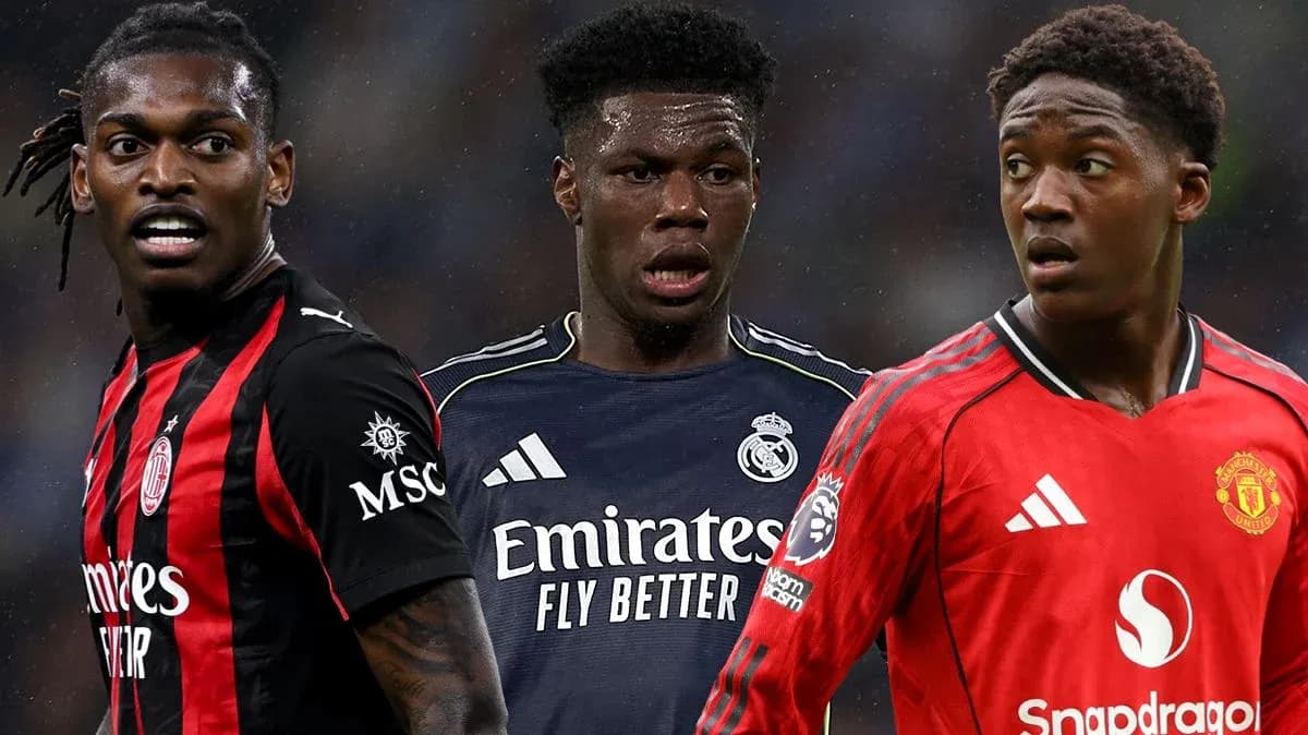 Three football players in club jerseys posing together