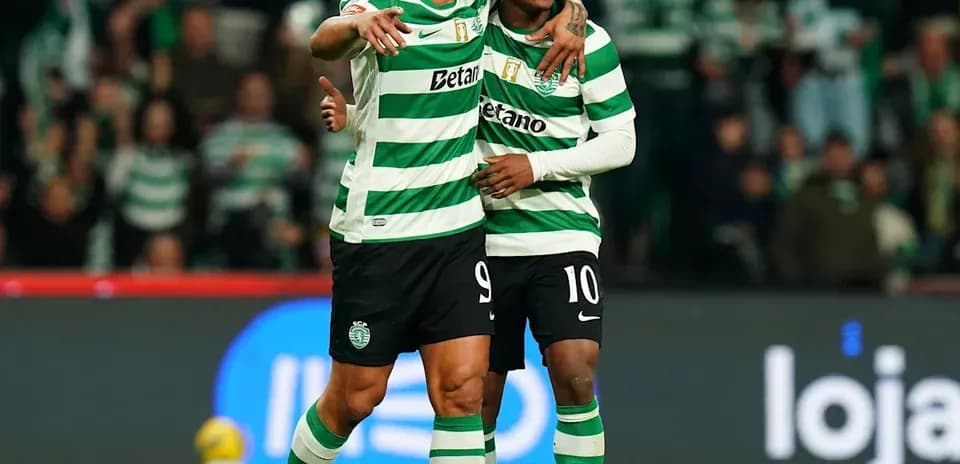 Two players celebrating a goal on the field