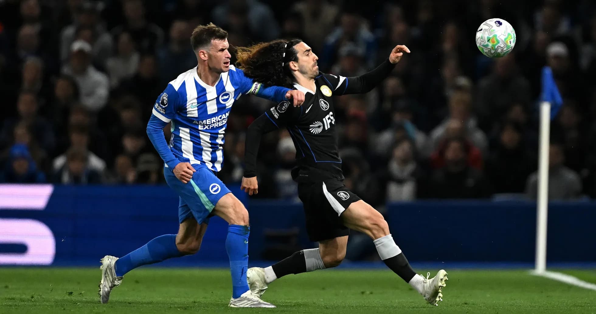 Brighton player challenges Chelsea opponent for the ball