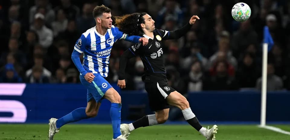 Brighton player challenges Chelsea opponent for the ball