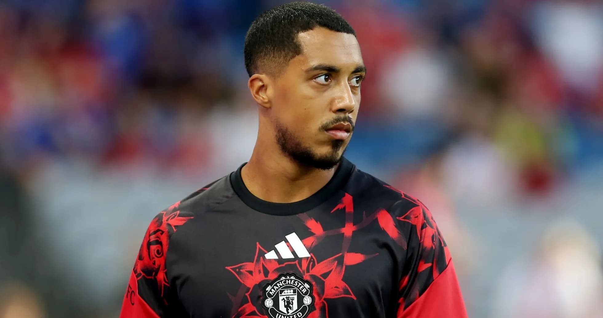 Player in Manchester United training kit on pitch