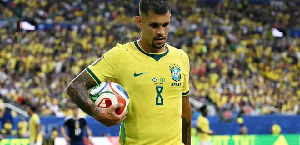 Brazilian player holding a soccer ball on field
