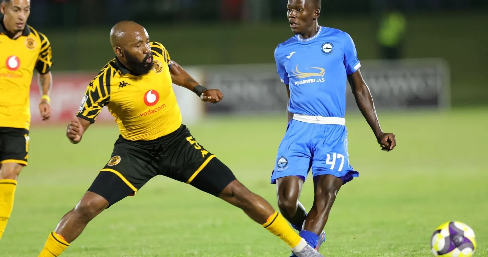 Player from Kaizer Chiefs evading tackle during match