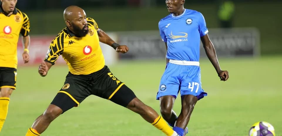 Player from Kaizer Chiefs evading tackle during match