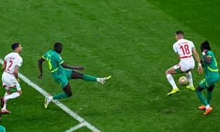 Players contesting the ball during a football match