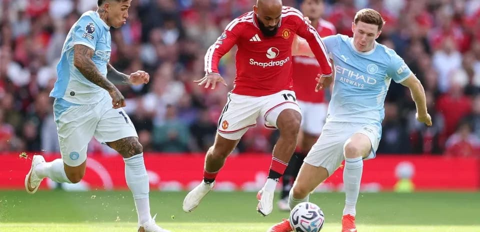 Players from Manchester United and Manchester City contesting the ball