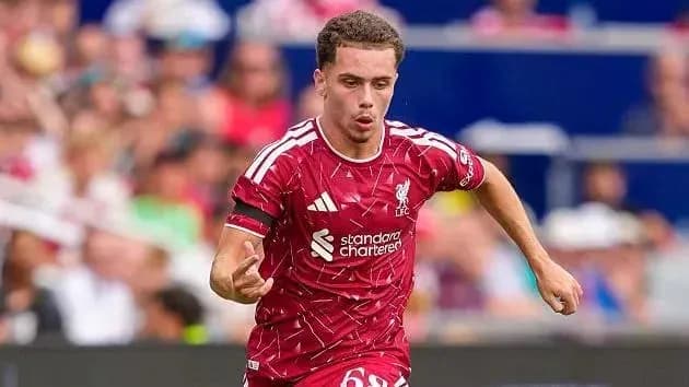 Player running with the ball in Liverpool kit