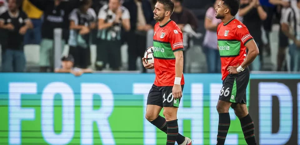Two players walking off the pitch after match