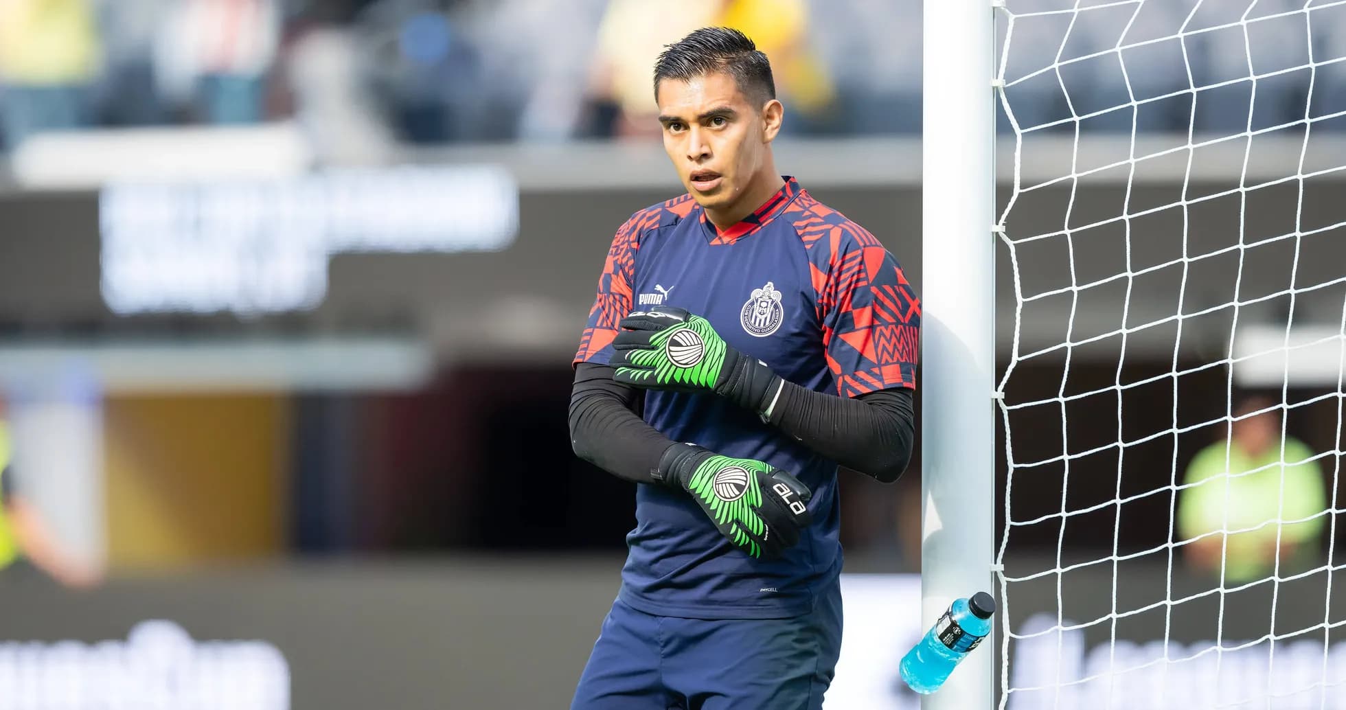 Goalkeeper warming up near the goal post