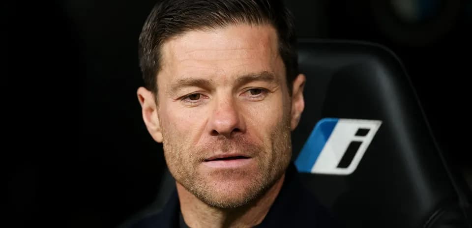 Coach seated on bench during match