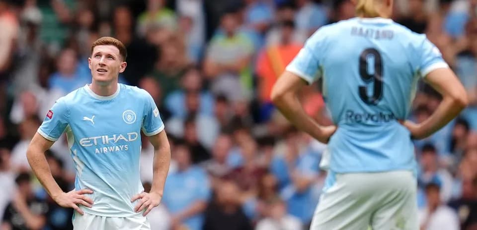 Manchester City players observing the match action