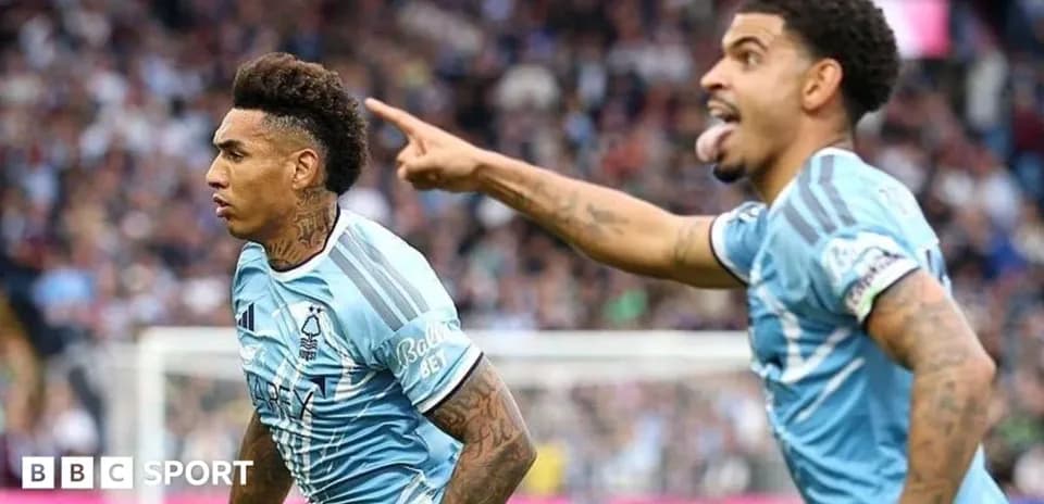 Two players celebrating a goal on the field