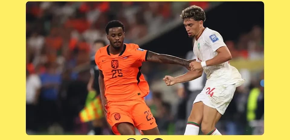 Players from Netherlands and Morocco competing for the ball