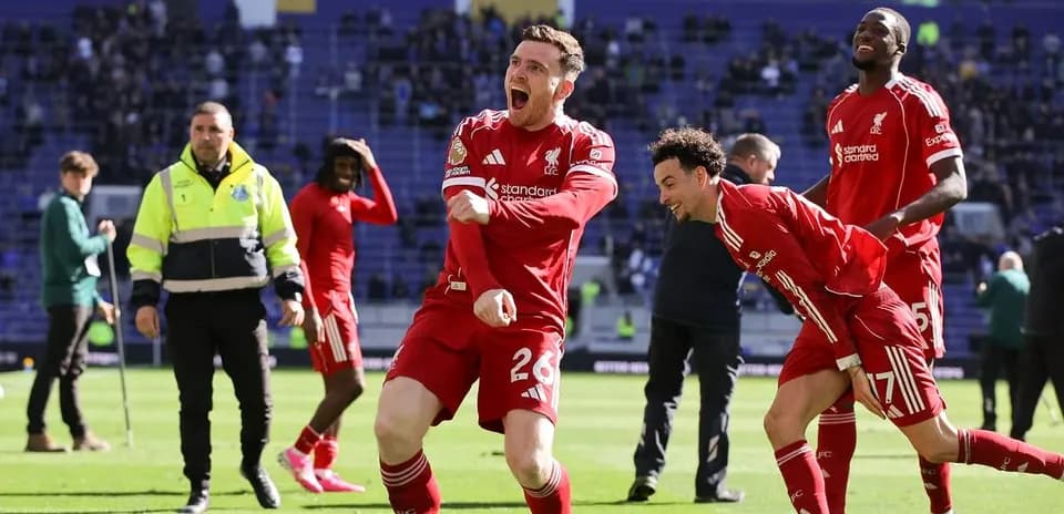 Liverpool players celebrating on the pitch after match
