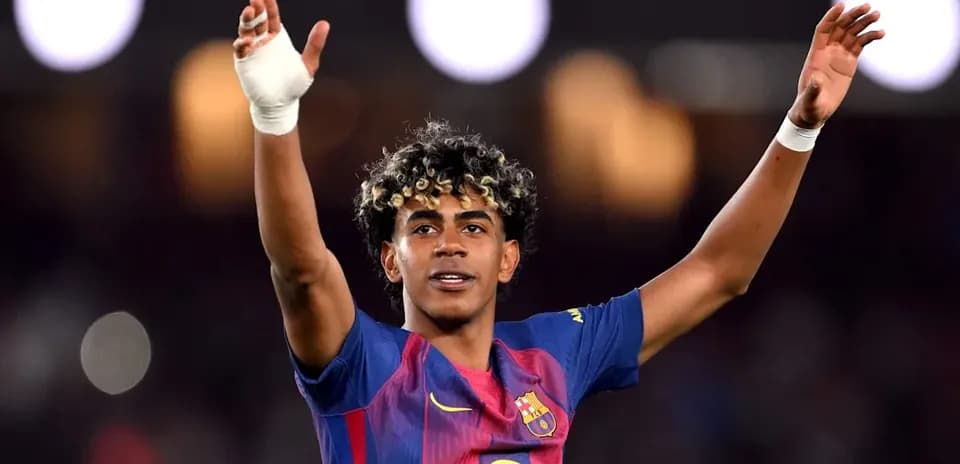 Player celebrating with raised arms in Barcelona jersey