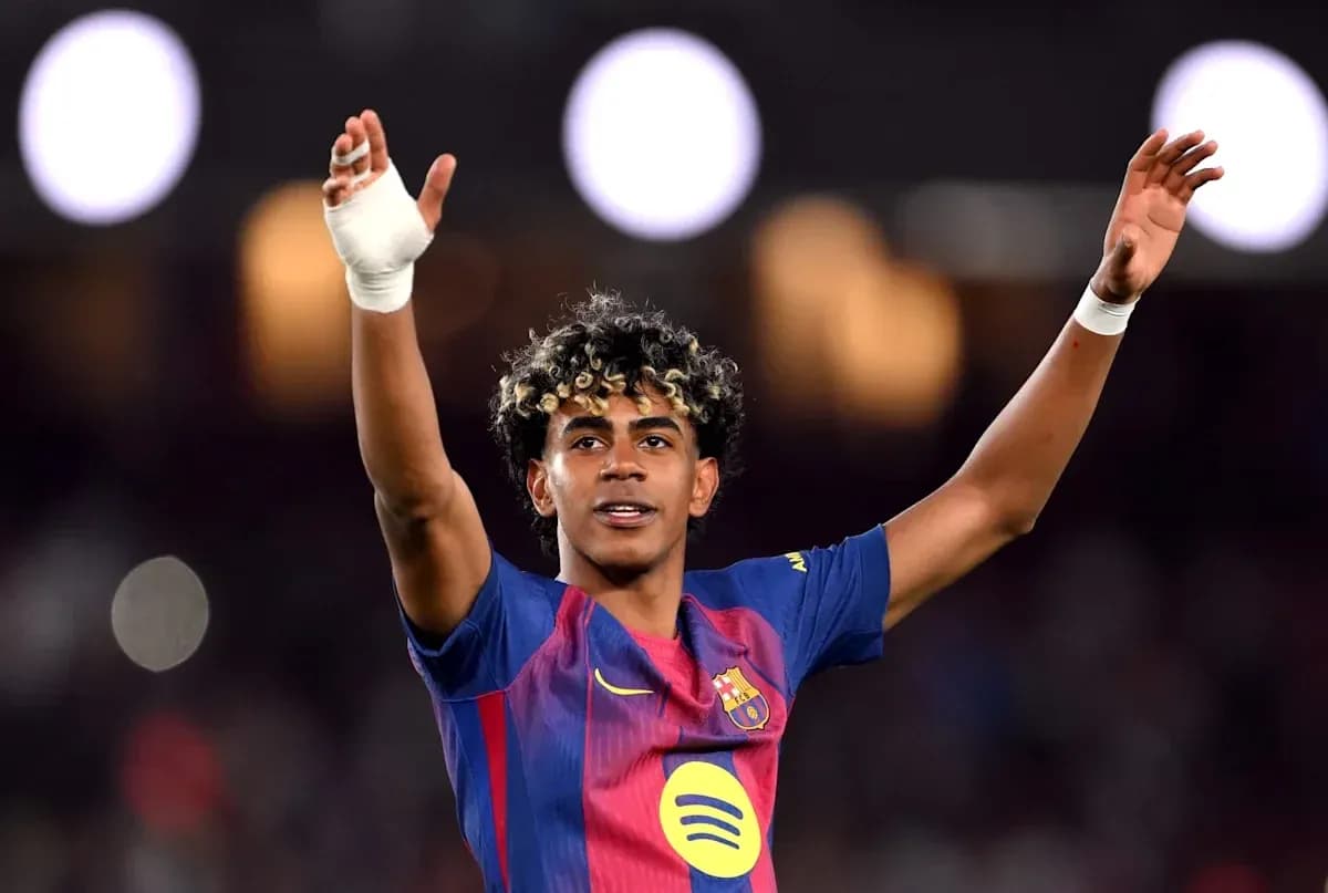 Player celebrating with raised arms in Barcelona jersey