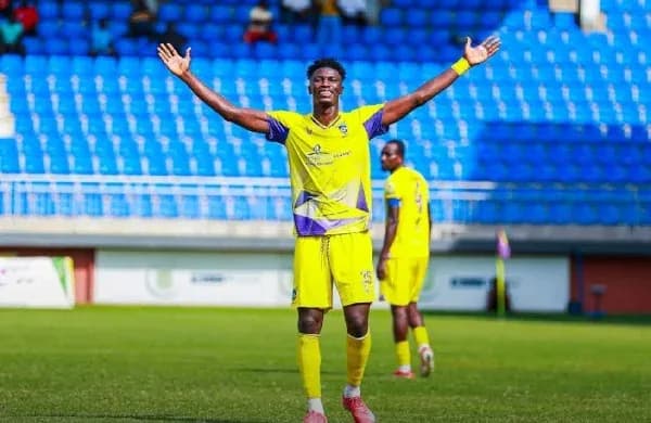 Player celebrating with arms raised on the field