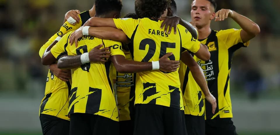 Team celebrating a goal with yellow jerseys
